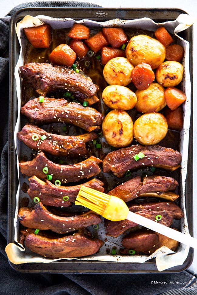 Pressure cooked Korean pork ribs, baby potatoes, and carrots on a baking tray.