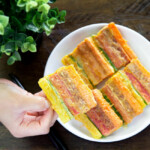 Holding cooked sanjeok (meat and vegetable skewers).