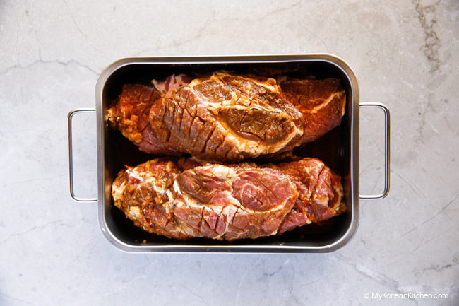 Overnight marinated Korean BBQ pork in a stainless steel tray.