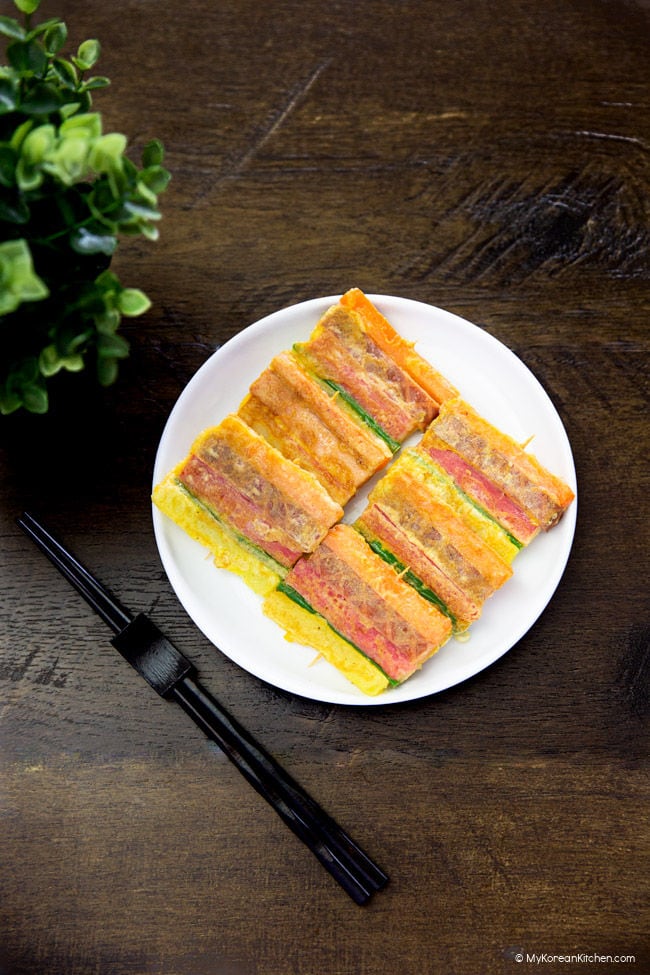 Sanjeok served on a white plate, laid on top of a wooden top.