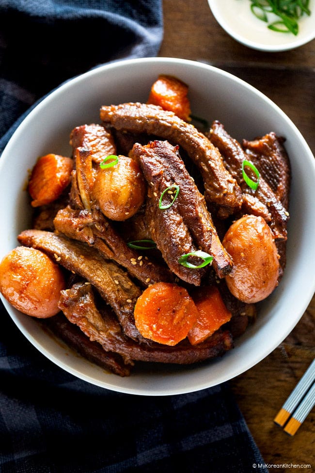 Pressure cooked pork ribs served on a pastel blue pasta bowl.