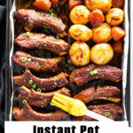 Pressured cooked Korean pork ribs, baby potatoes, and carrots on a baking tray.