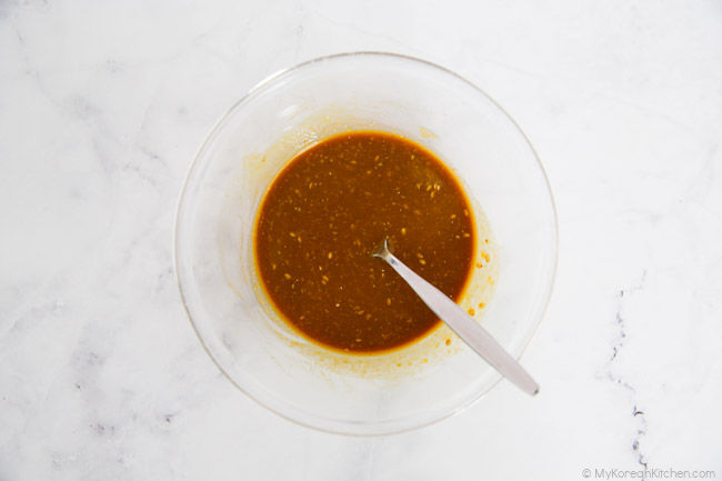 Mini kimbap dipping sauce in a small, clear bowl.