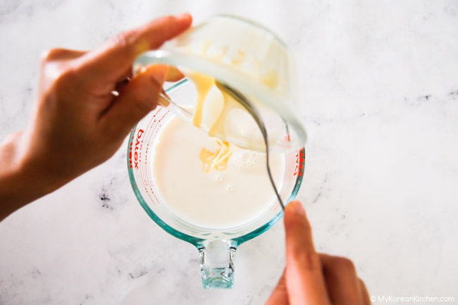Combining sweet condensed milk with a jug of milk and water.
