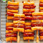 Sotteok skewers placed neatly on a stainless steel plate.
