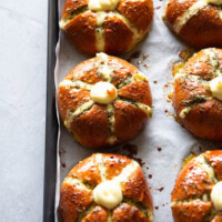 Baked cream cheese garlic bread on a baking tray, highlighting six cream cheese garlic buns.