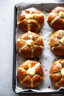 Baked cream cheese garlic bread on a baking tray, highlighting six cream cheese garlic buns.