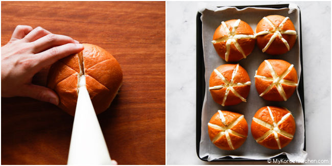 Piping cream cheese filling into the gaps of brioche buns.
