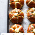 Baked cream cheese garlic bread on a baking tray, highlighting three cream cheese garlic buns.