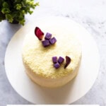 Top-down shot of a Korean sweet potato cake on a white cake stand.