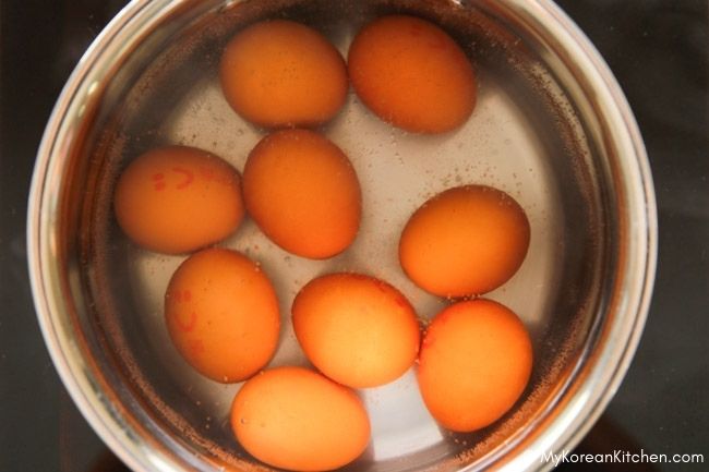 Boiling eggs in a pot of water.
