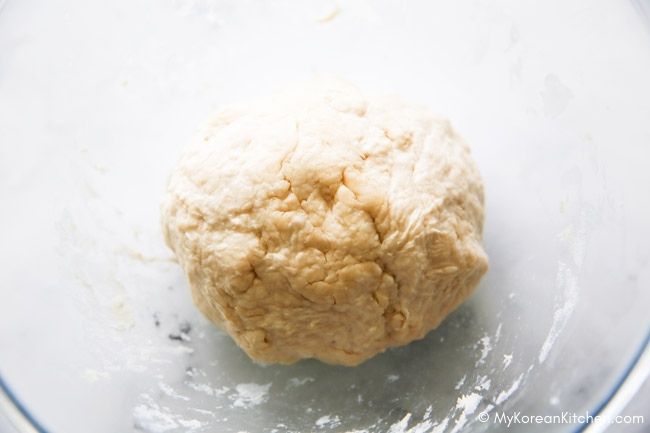 Knife-cut noodle dough resting in a bowl